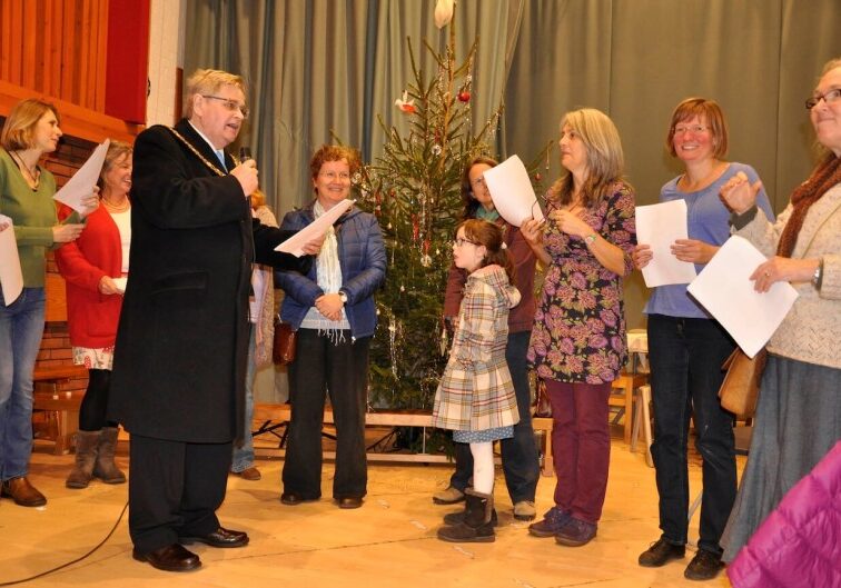 CAROLS. The Mayor in fine voice with the parents’ choir